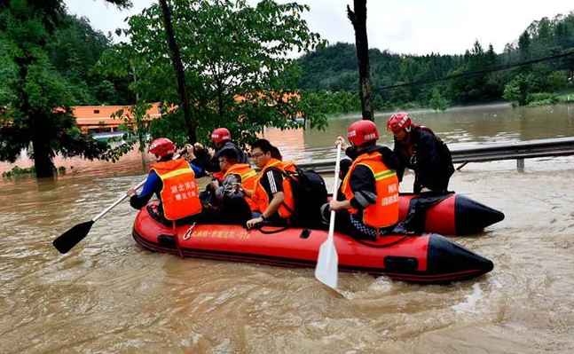 Firefighters rescue people from flood waters as torrential rains strike